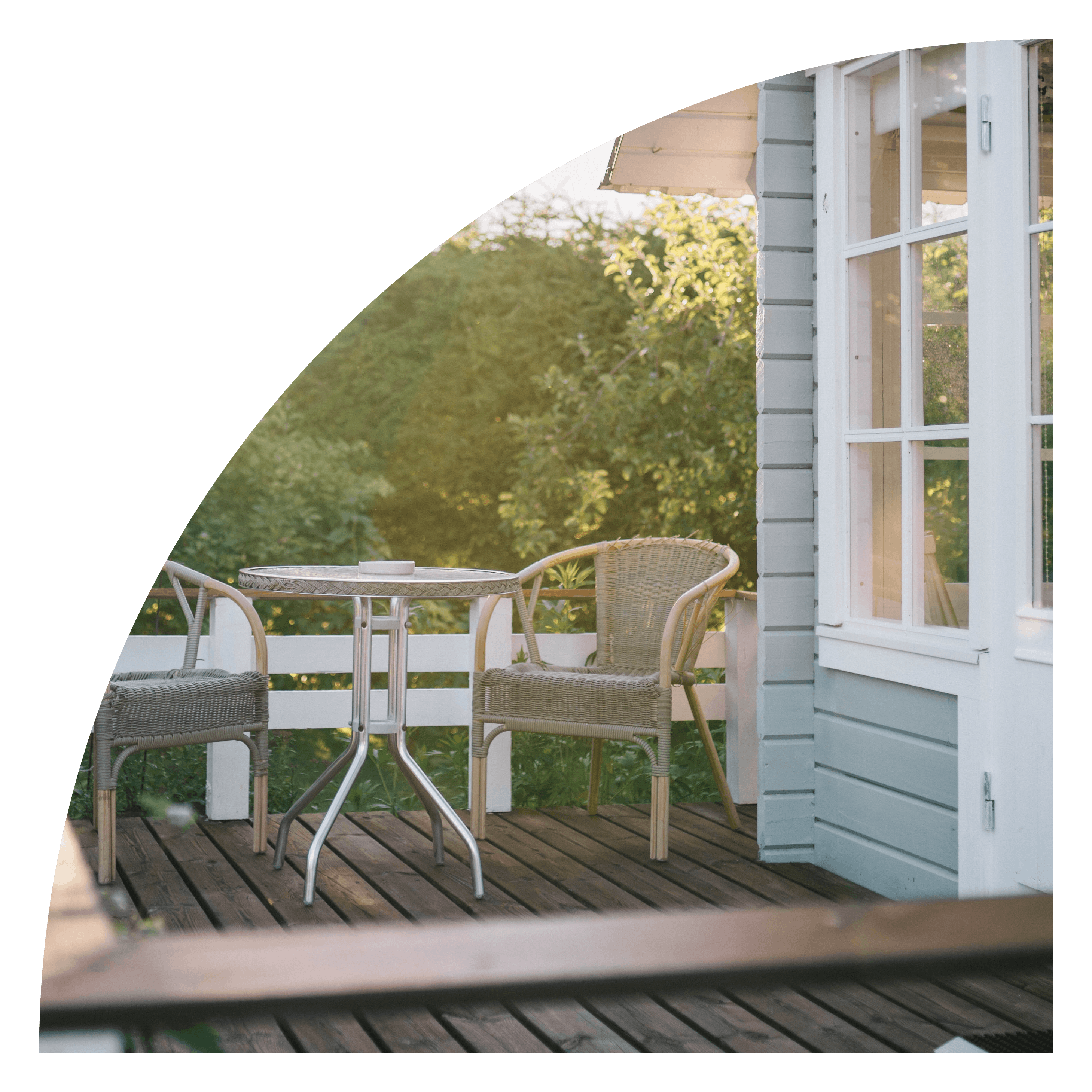 A porch with two chairs and a table